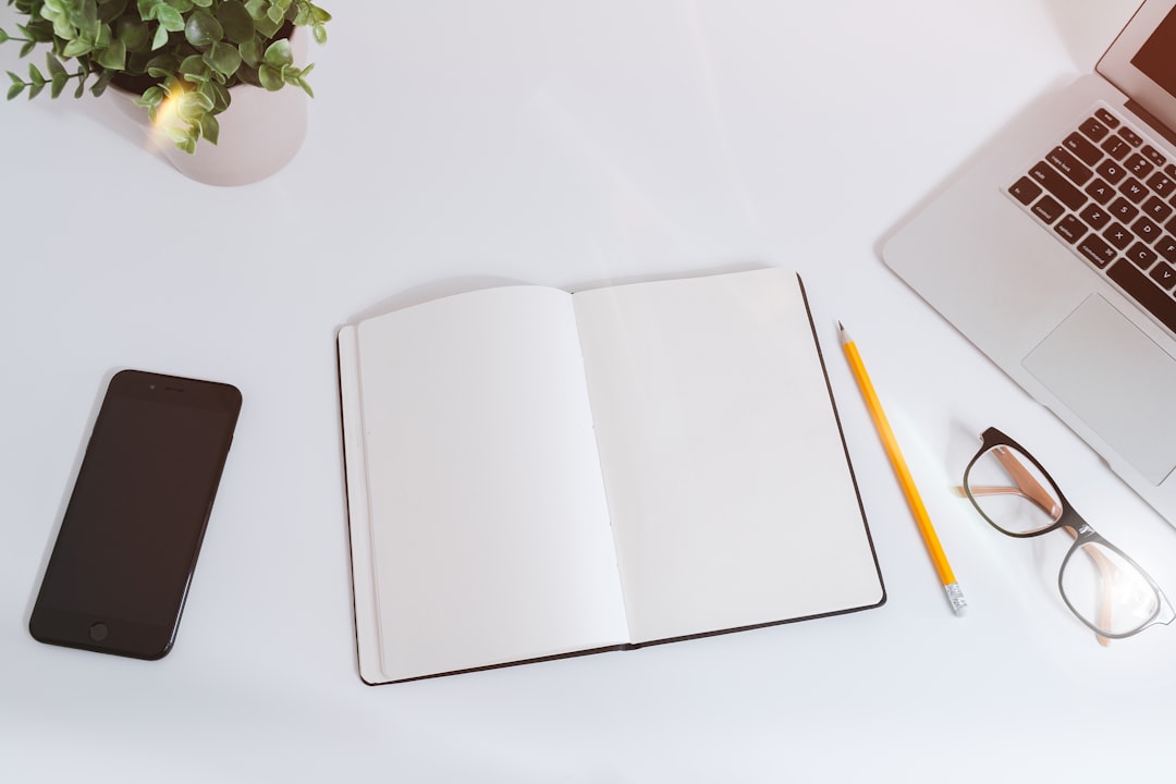 Notebook, laptop and planning tools in a bright workspace Notebook, laptop and planning tools in a bright workspace